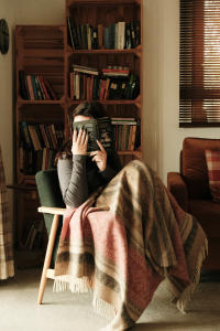 A woman holding a book to her face