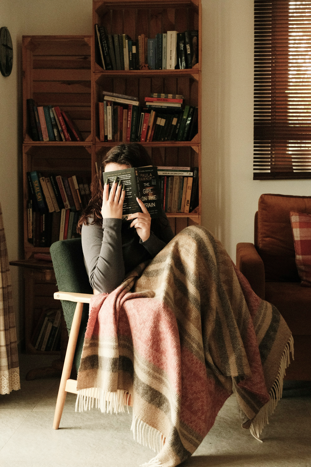 A woman holding a book to her face
