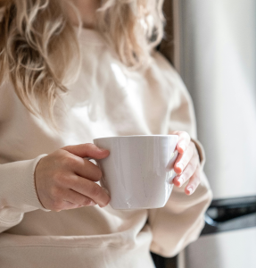 A woman holding a coffee mug